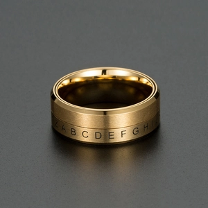 Close-up of golden titanium steel ring with rotating alphabet letters and brushed finish