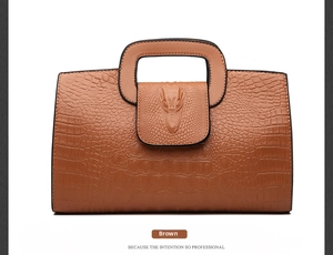 Detailed view of brown crocodile embossed pattern and unique alligator logo on handbag
