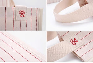 Detailed close-up of embroidery and woven texture on striped canvas shoulder bag