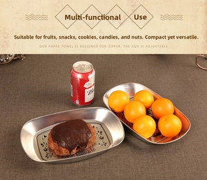 Detail of vintage silver oval metal tray with engraved patterns on rustic brown tabletop