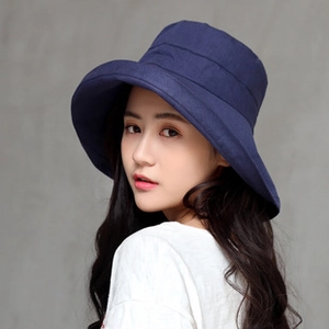 Close-up of navy blue wide-brim sun hat for women with high-quality linen texture