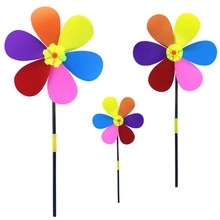 Detailed close-up of rainbow petal pinwheel toys with colorful petals and black handles