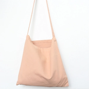 Detailed view of pale pink cotton canvas bag with neat stitching and simple shoulder strap