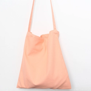 Detail of minimalist orange cotton canvas tote bag with durable shoulder strap