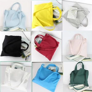 Minimalist canvas tote bag shown in nine vibrant colors with dual shoulder straps