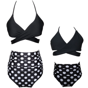 Flat lay detail of black halter neck bikini top and polka dot high waisted swim bottoms