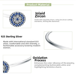 Detail of 925 sterling silver evil eye bangle with blue and white zircon stones