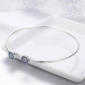 Sparkling S925 sterling silver open bangle featuring brilliant blue devil eye cubic zirconia