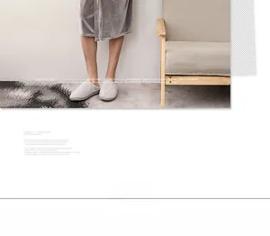 Close-up of grey velvet slippers paired with a matching long luxury lounge robe