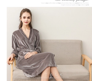 Detail view of a luxury grey velvet bathrobe featuring elegant white piping and waist tie