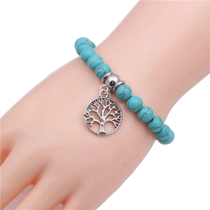 Green turquoise 8mm beaded bracelet with silver Tree of Life charm on a model's wrist
