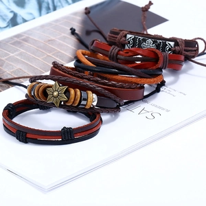 Detail of vintage 6-piece multilayer leather bracelets with woven cords and beads