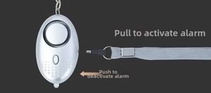 Detail view of silver personal alarm showing pull-to-activate and push-to-close mechanism