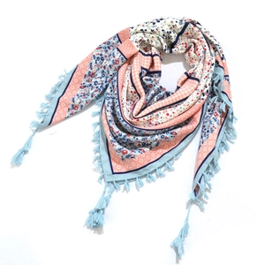 Detailed flat lay of bohemian triangular scarf featuring floral patterns and light blue tassels