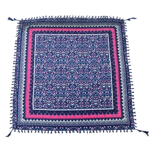 Detailed view of bohemian square scarf featuring intricate floral patterns and tassels