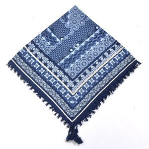 Detailed view of bohemian square scarf with blue paisley patterns and corner tassels