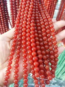 Close-up of 8mm red agate beads on a stainless steel chain necklace detail