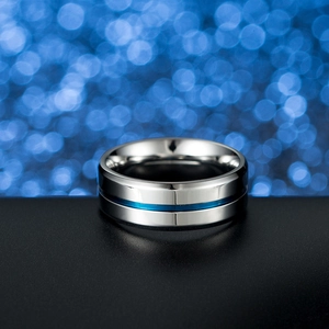 Polished stainless steel ring with blue center stripe detail on black surface