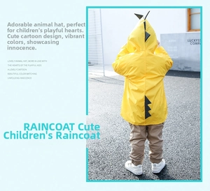 Detail view of yellow dinosaur raincoat with creative grey dorsal fins for children