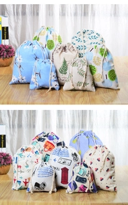 Detailed display of printed linen drawstring storage bags on a wooden surface