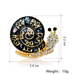 Vintage cartoon snail brooch with black enamel and gold accents, 2.2 cm by 2.5 cm size