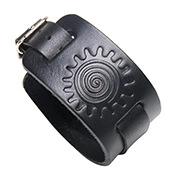Detailed view of black leather wide wristband with embossed sun and spiral patterns and buckle