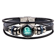 Macro detail of multi-layer black leather bracelet with Libra zodiac glass dome and metal beads
