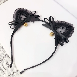 Close-up of black lace cat ears headband with silk bows and small golden bells