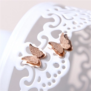 Frosted double-layered 18K rose gold butterfly stud earrings on white decorative stand