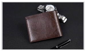 Detail view of dark brown leather short wallet with business pen and watch accessories