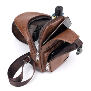 Brown leather crossbody sling bag with USB port and organized interior storage pockets