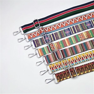 Close-up of adjustable woven bag straps featuring colorful ethnic patterns and metal hooks