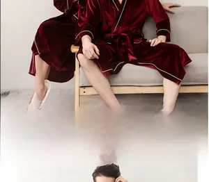 Detail of burgundy velvet robe with white piping and high-quality plush fabric texture