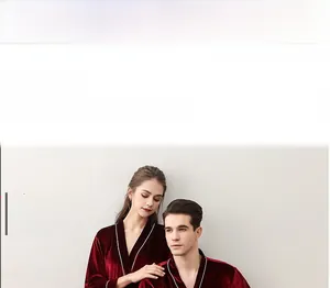 Detail of red velvet bath robe featuring elegant white piping on the V-neck collar