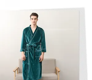 Detail of teal velvet men's long robe with white piping and waist belt on a model