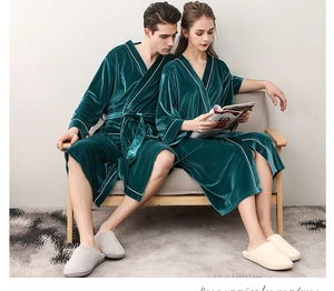 Macro detail of dark green velvet robe showing soft texture and contrast white piping