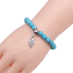 8mm blue turquoise beaded bracelet featuring a vintage silver owl charm on elastic cord