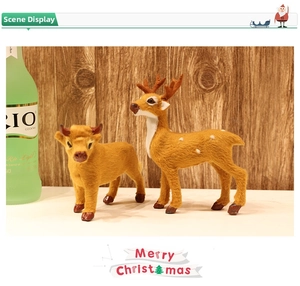 Detail view of lifelike Christmas reindeer and calf figures with soft flocked texture