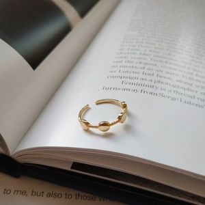 Detailed macro shot of S925 sterling silver stamp on a minimalist gold open ring