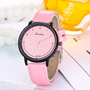 Close-up of a pink quartz watch with a black case on a decorative white background
