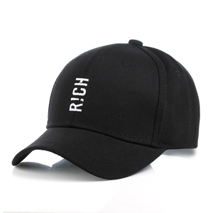 Detailed close-up of a black cotton baseball cap featuring white RICH embroidery