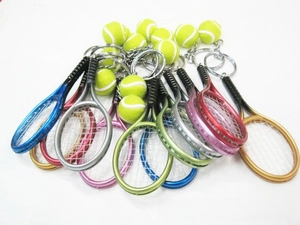 Macro view of colorful mini tennis racket and ball keychain sets with textured details