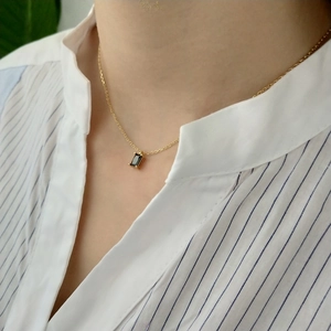 925 sterling silver gold chain necklace with black rectangular gemstone on a model