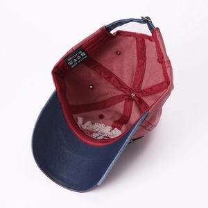 Inside view of red and blue cotton baseball cap showing LA embroidery and material labels