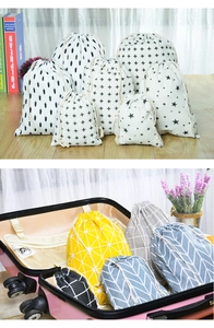 Various patterned linen drawstring bags for travel luggage and home organization