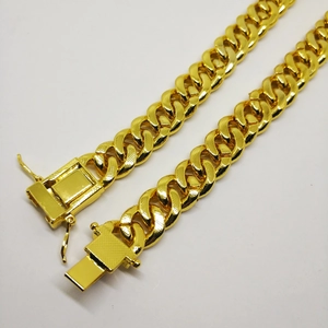 Detail of 12mm 18K gold plated Cuban link chain showing the clasp and textures