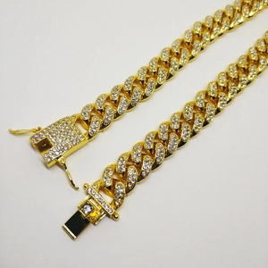 Macro shot of gold-plated 12mm Cuban link bracelet with full diamond inlay and square clasp