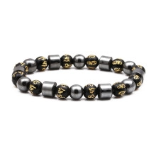 Detailed view of 8mm black stone beads with golden mantra symbols and hematite cylinders