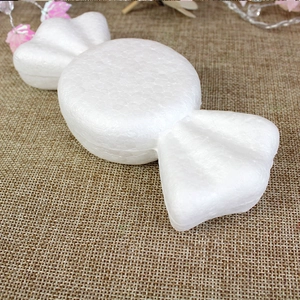 Macro detail of white polystyrene candy shape foam for DIY crafts on burlap background