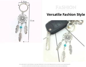 Detail view of silver dreamcatcher keychain with feathers and turquoise bead accents